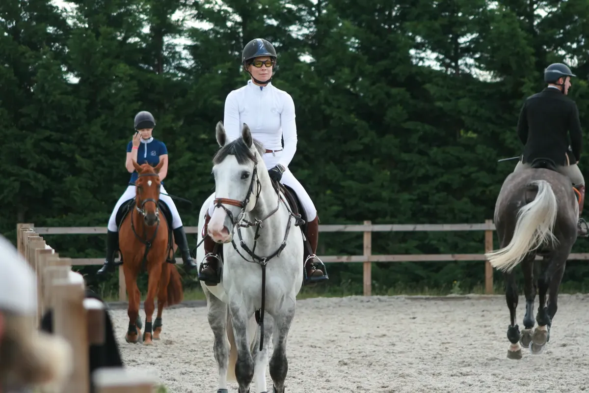 Riders and their horses in the arena at Pentonville Lodge