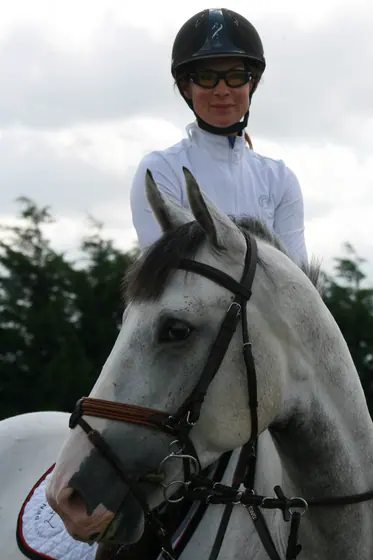 Close-up of a rider on a grey