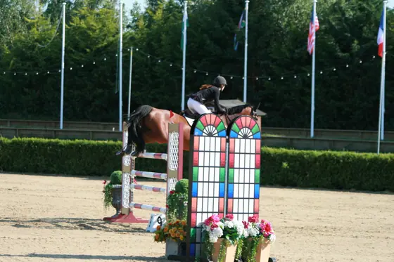 A bay jumping a colourful wall