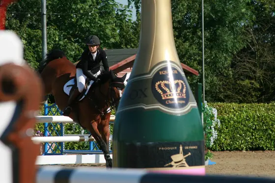 A bay jumping past champagne bottle wings