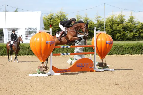 A bay jumping between orange balloon wings