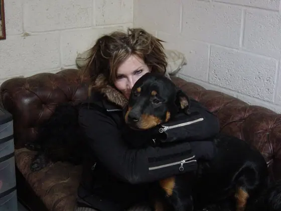 Cuddling a Rottweiler on the sofa