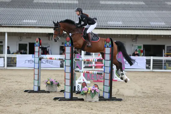 Nikki Ward jumping at a summer show