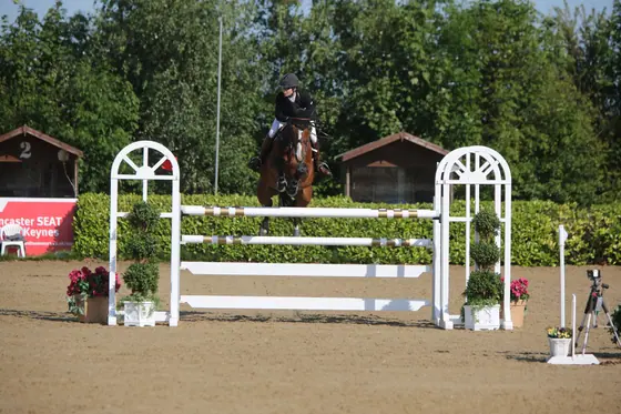 Nikki Ward jumping at a summer show