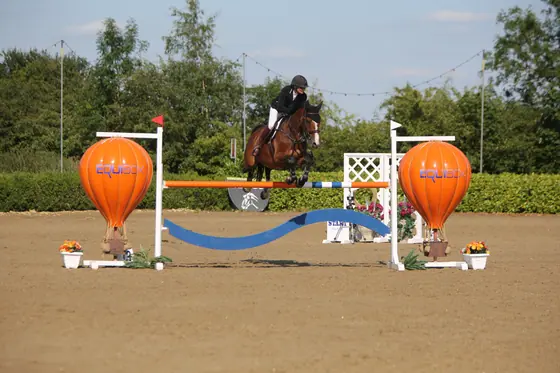 Nikki Ward jumping at a summer show
