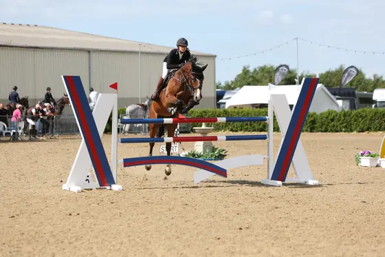 Nikki Ward jumping at a summer show